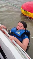 Woman Falls Into Water as Floating Tube Flips