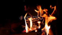 Bright fire on dark background. Wooden logs burning in beautiful vivid fire in fireplace.