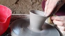 Artist shapes mugs from clay during calm pottery studio session