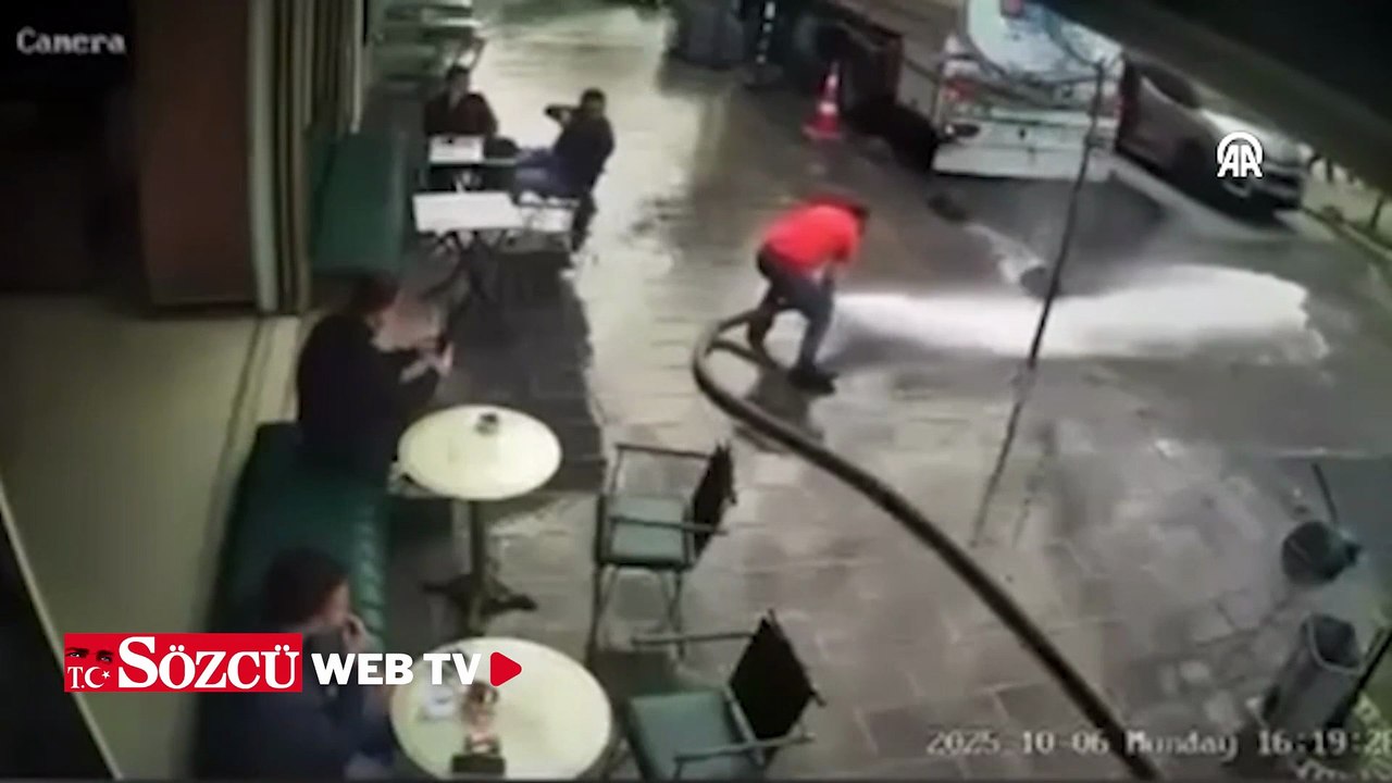 Bir kişinin tazyikli suyla çevredekileri ıslatması kamerada