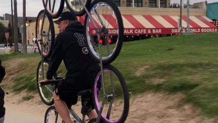 Rider shows off his bike with neon lights at Venice beach parade