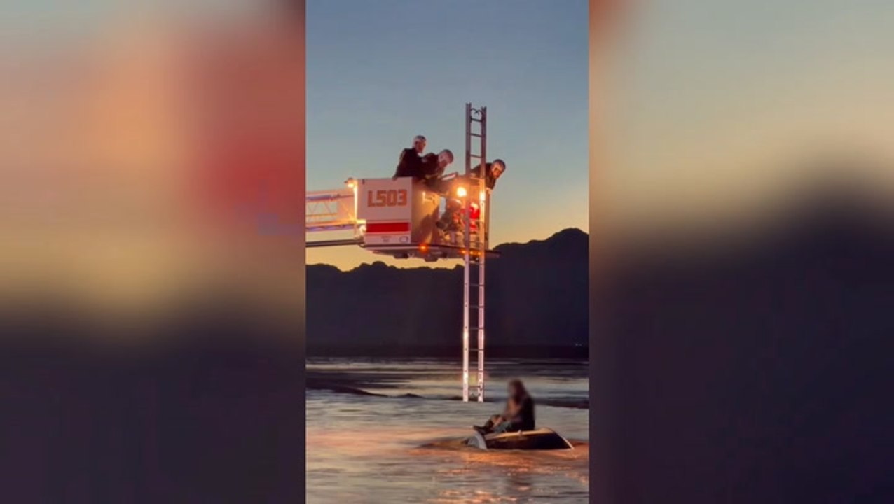 Man and baby rescued from roof of car as sweeping floodwaters surround vehicle in dramatic video
