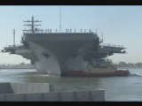 Fleet tug boats push USS Ronald Reagan away from the pier