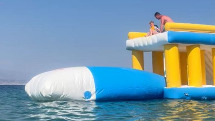 Kid launched high into the air from a giant inflatable bag during water park adventure