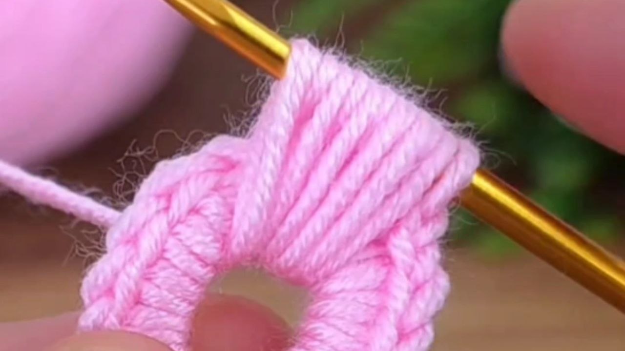 Loops and stitches join forces as an artist crochets a flower motif