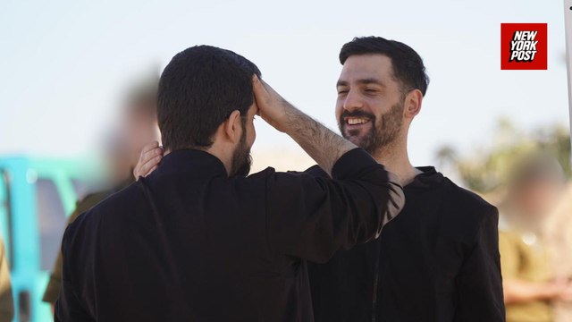 Twin brothers among released hostages greeted by cheers as they're taken to hospital
