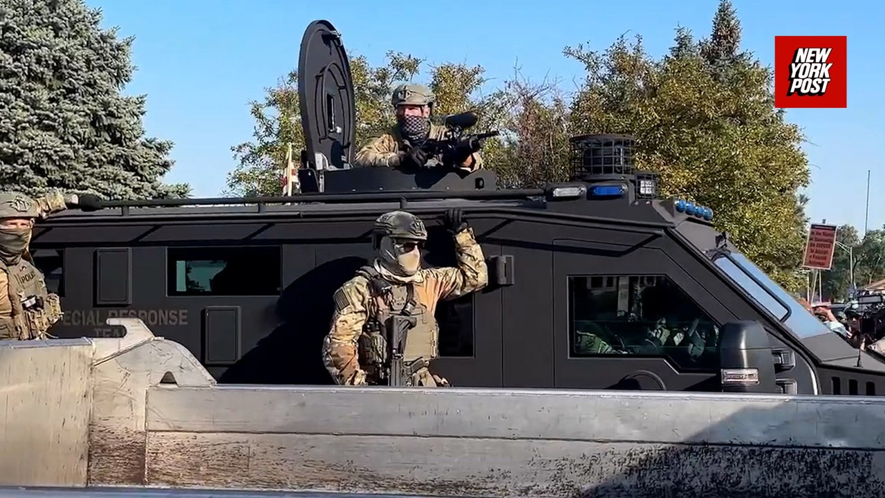 Armored vehicle rolls past protestors outside suburban Chicago ICE facility