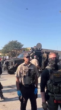 Armored vehicle rolls past protestors outside suburban Chicago ICE facility