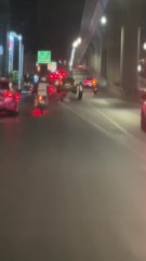 Car seen balancing on divider in Bangkok
