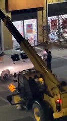 Britain... Thieves stole an ATM using a crane, placed it on a vehicle, and fled.