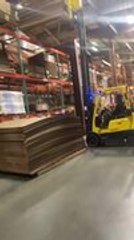 Pallet of Wooden Sheets Falls Off Forklift as Operator Reverses it