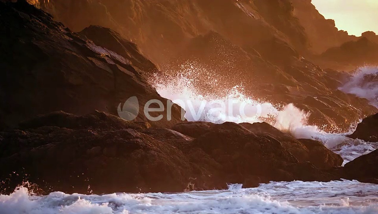 Ocean Waves Crashing On The Rocky Coastline And Cliffs During Golden Hour. - slow motion, zoom in sh