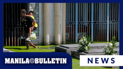 People visit loved ones’ tombs at flooded Masantol Cemetery in Pampanga
