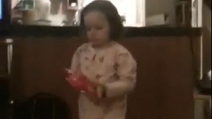 Little girl dances for a packet of crisps but falls on the floor