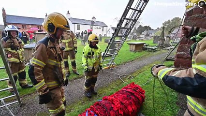 Baschurch Fire Service help raise a giant Poppy display up on All Saints Church tower, Baschurch.