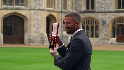 Beckham poses with wife Victoria after receiving knighthood