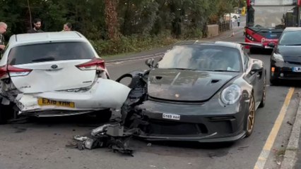Aftermath of a serious and costly accident shows a crashed Porsche on the road