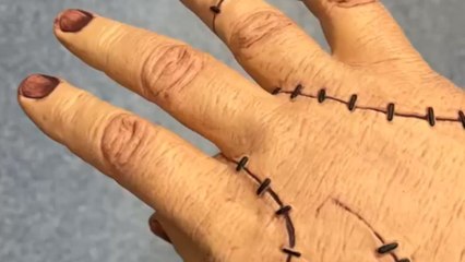 Mom puts on a creepy prop hand to give her little boy a scare