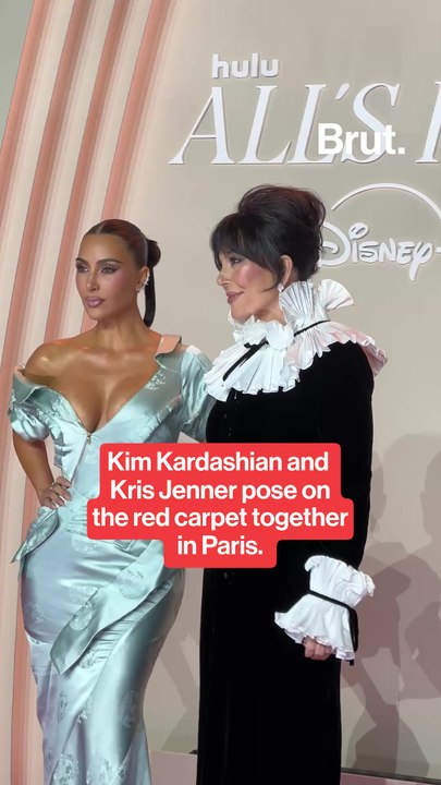 Kim Kardashian poses Kris Jenner on the red carpet.
