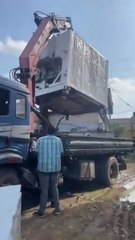 Forklift Crane Accident: Heavy Machinery Falls Off Truck During Loading