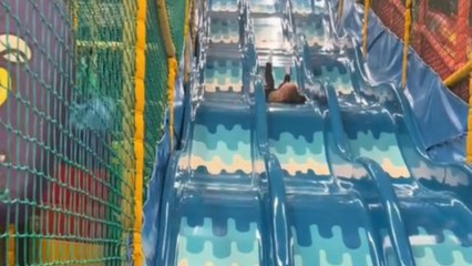 Girl attempts to slide backwards against advice and experiences a comical bumpy descent