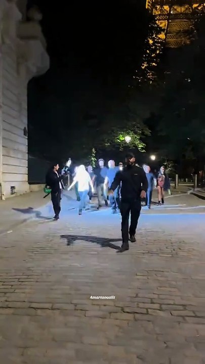 Billie Eilish strolls around the Eiffel Tower and hides from the paparazzi in Paris.