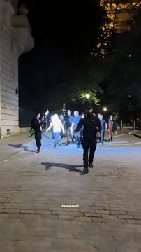 Billie Eilish strolls around the Eiffel Tower and hides from the paparazzi in Paris.