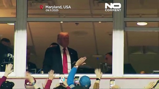 Donald Trump cheered and booed as first sitting US president at regular-season NFL game since 1978