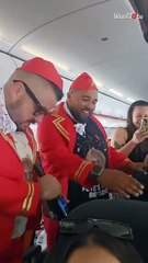 Best friends dressed as flight attendants surprise man on plane for milestone birthday trip