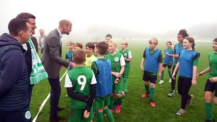 William greets young footballers as he opens new access road