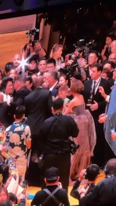 Cynthia Erivo rushes to protect Ariana Grande from a charging fan on the red carpet in Singapore