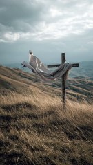 Cross on a hillside with a shawl on it blowing