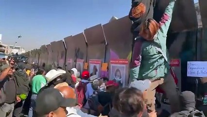 Protesters rip down palace barriers in Mexico City clash with police