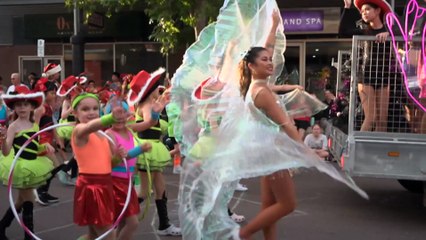 Christmas arrives early in Darwin as local communities celebrate in a festive street parade.