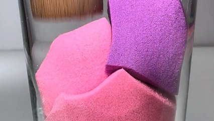 Visually delightful footage of colorful kinetic sand cubes getting ground in a glass