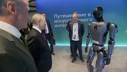 Putin stares down dancing robot in awkward encounter at AI conference