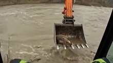 Construction Worker Uses Excavator to...
