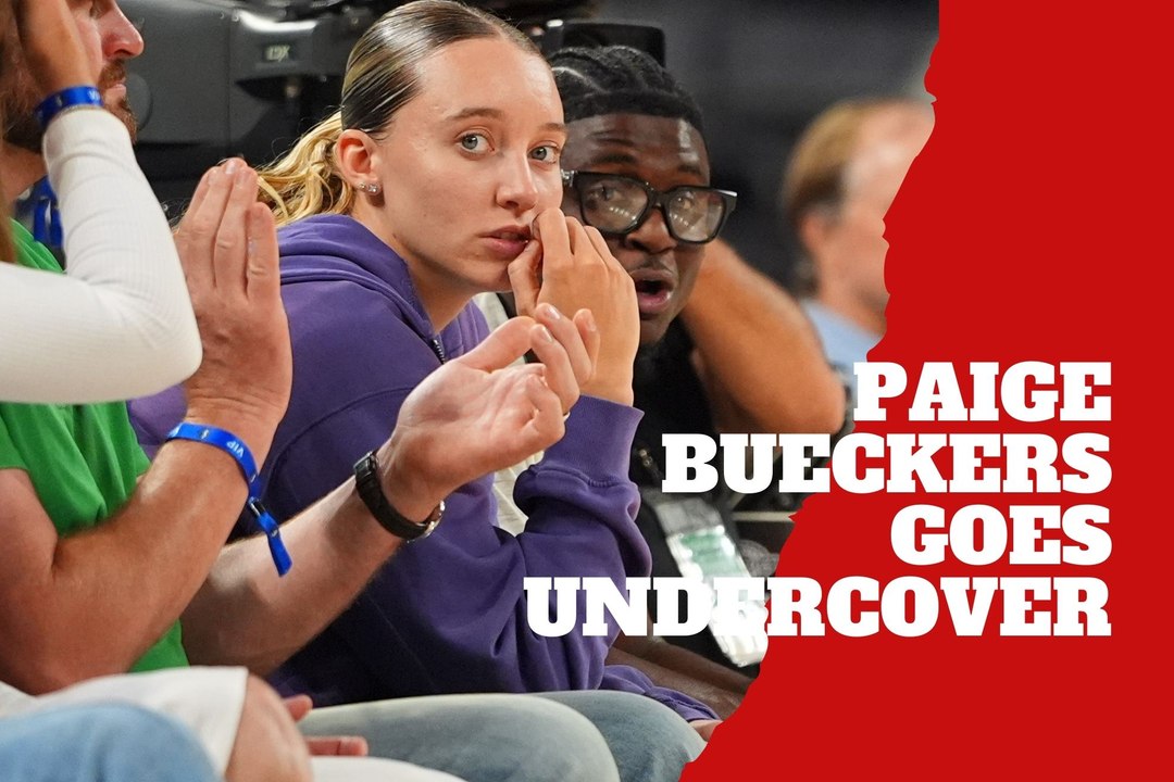 Paige Bueckers hides from fans during an NBA game