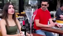Woman Taking Giant Glass of Wine And Man Taking A Giant Cup of Coffee