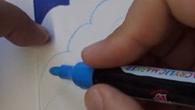 Artist paints a small triangular canvas using different shades of blue