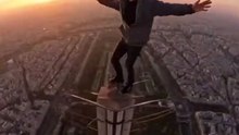 A man on top of the Eiffel Tower in Paris