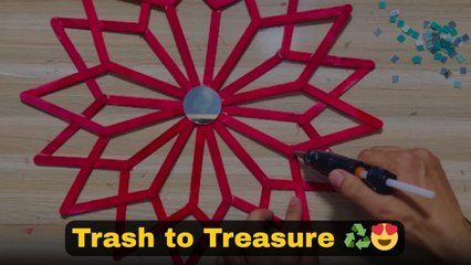 DIY wall decor made from popsicle sticks, fabric pieces and mirror shards