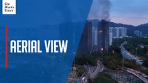 Drone footage shows thick smoke rising from charred Hong Kong towers