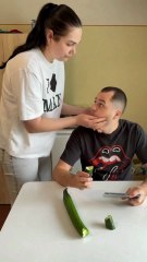 The couple fights over the cucumber to eat