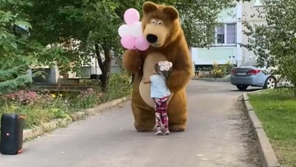 Little girl sees a bear from a cartoon series and runs for a hug