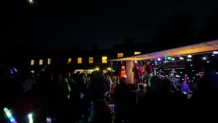 MC Rob Pudner and the Grinch shared a 'Christmas kiss' on stage as the lights were switched on (Will Goddard, Crediton Courier)