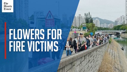 Hong Kong fire: Thousands line up to lay flowers