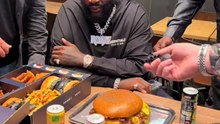 Rick Ross tries a burger at Black and White in La Défense, Paris.