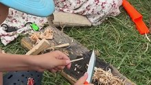 In the quiet of the woods, young hands learn steady, respectful knife skills under careful guidance.