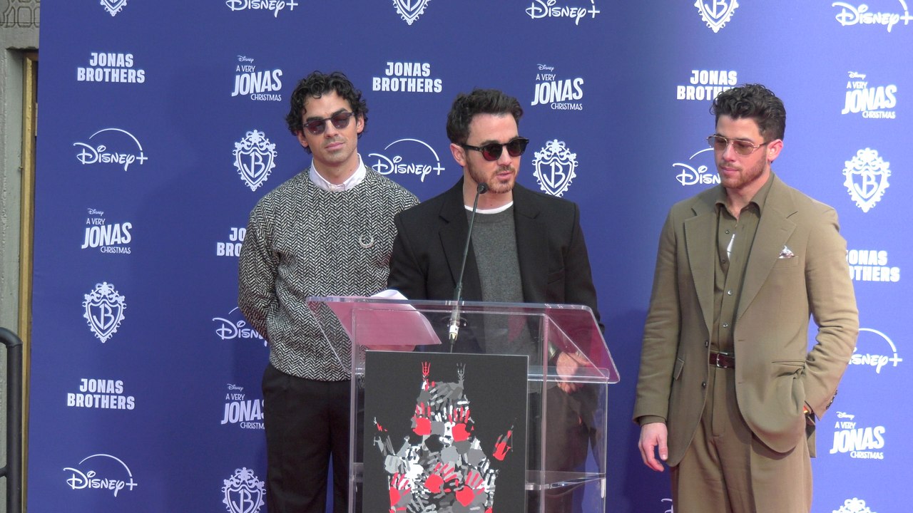 The Jonas Brothers give a speech at their handprint-footprint ceremony in Hollywood